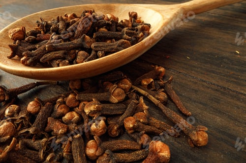 Preview: Heap of clove spice on wooden table
