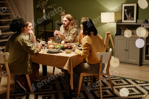 Preview: People sitting at dinner party at home