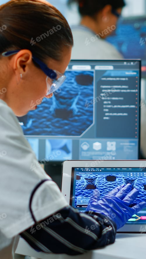 Preview: Scientist using digital tablet working in modern medical research laboratory