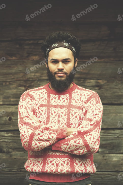 Preview: portrait of young hipster in front of wooden house