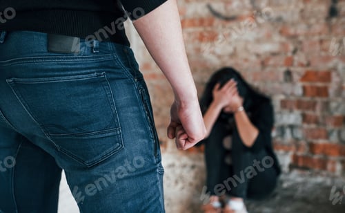 Preview: Violent man standing and threatens girl that sits on the floor with teddy bear in abandoned building