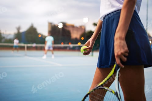 Preview: Young handsome tennis player with racket and ball prepares to serve at beginning of game or match