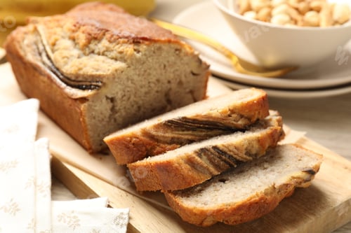 Preview: Pieces of banana bread with nuts on table, closeup