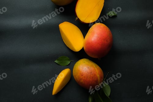 Preview: Mango background design concept. Top view of fresh mango fruit pattern with leaves on table.