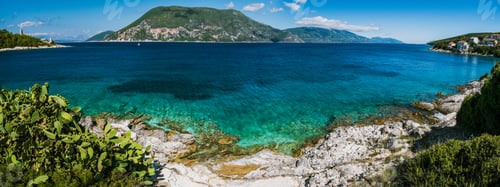 Preview: Panorama of crystal clear transparent blue turquoise teal Mediterranean seascape in Fiskardo town