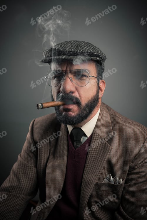 Preview: Hispanic businessman smoking his cigar isolated on gray background