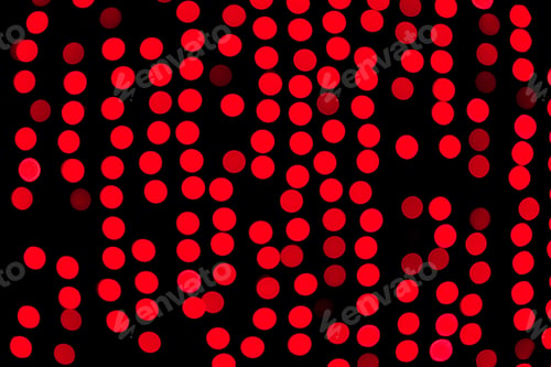 Preview: Unfocused abstract red bokeh on black background. defocused and blurred many round light