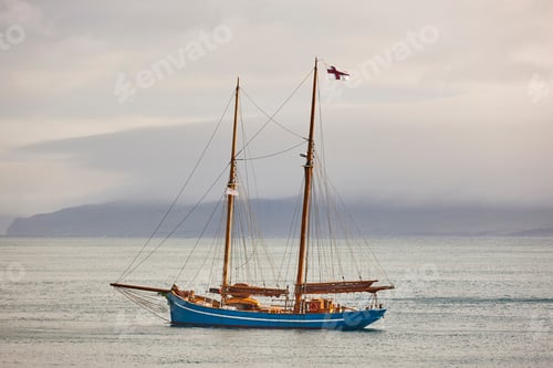 Preview: Yacht sailing on Faroe island fjords. Atlantic ocean coastline. Travelling