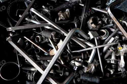 Preview: A disorganized assortment of metal tools and hardware components.