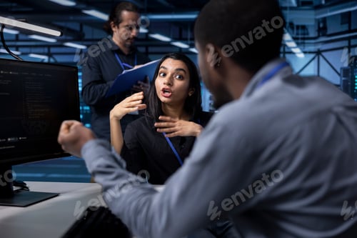 Preview: IT staff members in server room ensuring data remains shielded