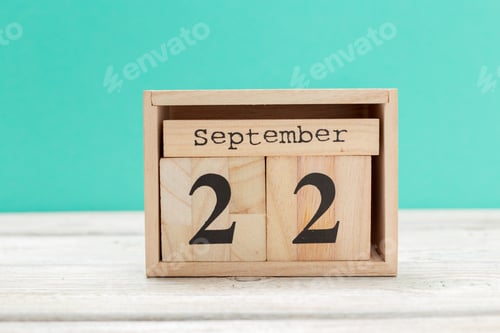 Preview: wooden cube shape calendar for september 22 on wooden tabletop