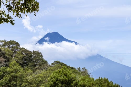 Preview: Beautiful landscape of Agua Volcano with a clear blue sky and lush green trees in Guatemala
