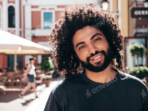 Preview: Handsome man posing outdoors at sunny day