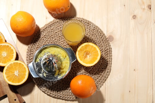 Preview: Freshly squeezed orange juice, fruits and juicer on wooden table, flat lay. Space for text