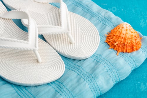Preview: White Flip Flops and Seashell on Blue Towel