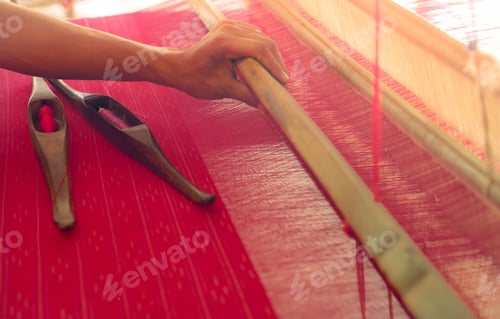 Preview: Woman working on weaving machine for weave handmade fabric. Textile weaving. Weaving using