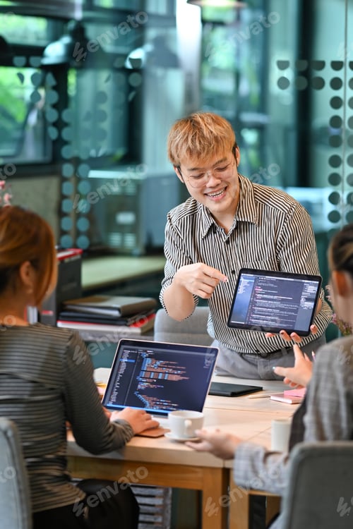 Preview: Group of creative software development sharing creative idea, working with coded data.