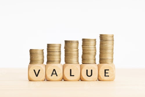 Preview: Value word on wooden blocks and rising stacked coins