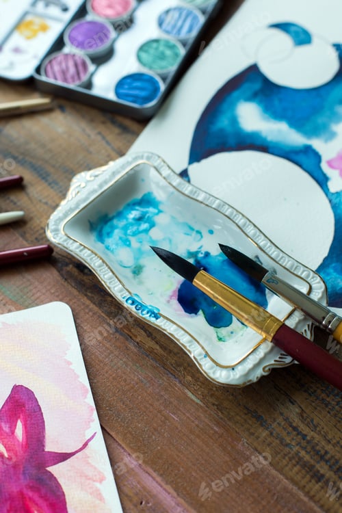 Preview: Watercolor Painting Tools and Artwork on Wood Table