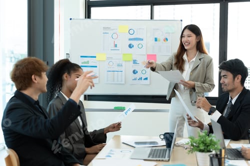 Preview: Business people discussing documents and ideas at meeting