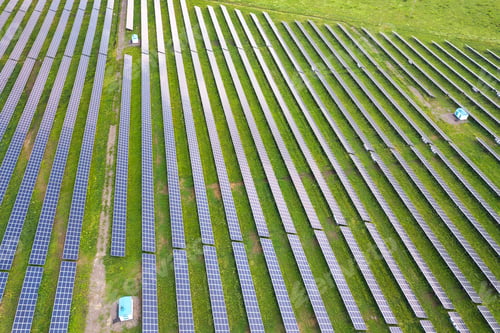 Preview: Aerial view of solar power plant on green field.