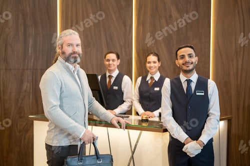 Preview: Hotel staff and mature male traveler