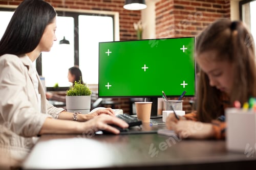 Preview: Woman using computer with greenscreen