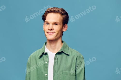 Preview: Male Model Showcasing Cool Casual Style Against Modern Blue Studio Wall