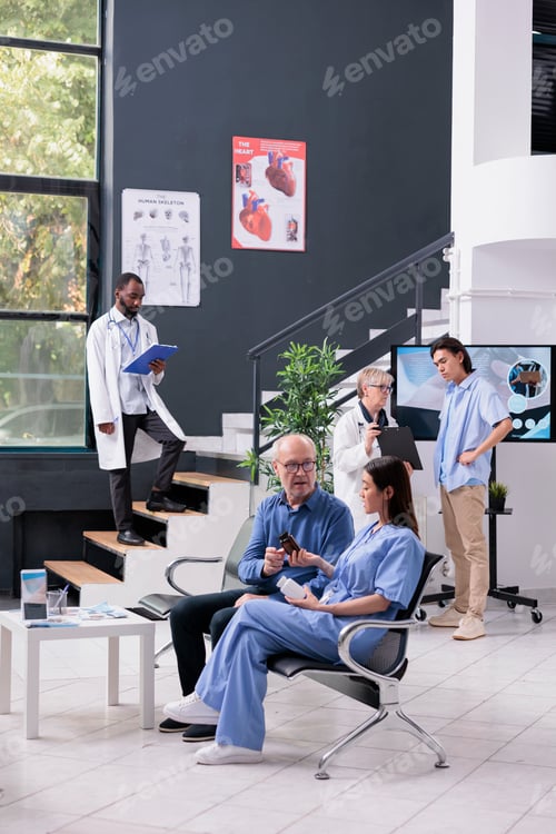 Preview: Nurse sitting beside senior patient while discussing medication treatment during checkup examination
