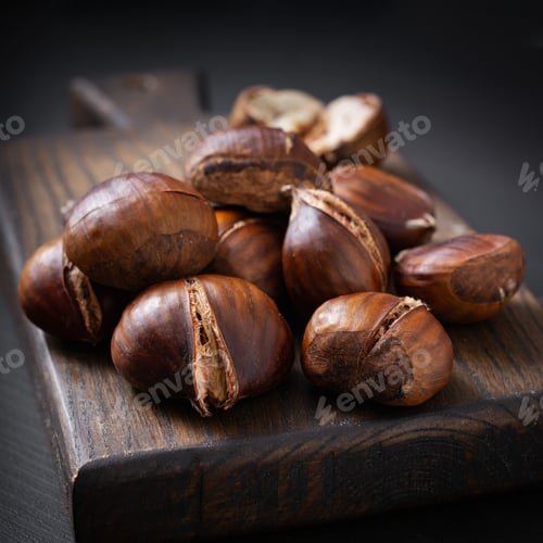 Preview: Roasted chestnuts on dark wooden background
