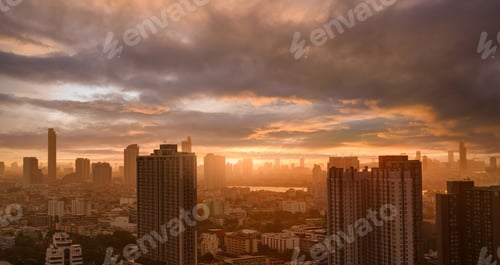 Preview: Cityscape with skyscraper building and morning sunlight. Riverfront city with orange sunrise. Urban