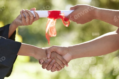 Preview: Closeup shot of an unrecognizable graduate receiving their certificate on graduation day