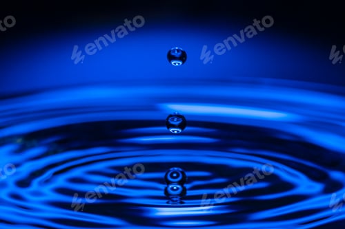 Preview: Macro water drop on a blue background and circles on it. Round water drop