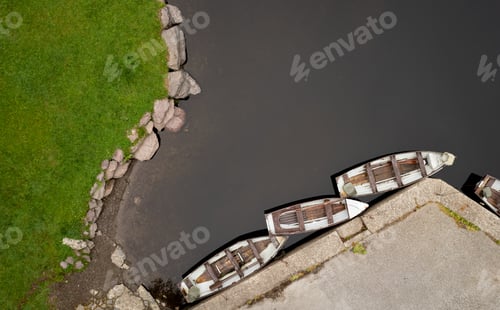 Preview: Drone aerial scenery of a river with boat moored on the river side. Keimeens Ireland County