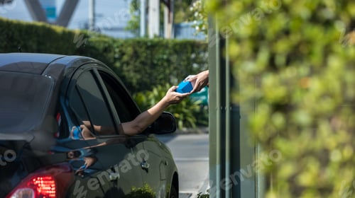 Preview: Hand Man in car receiving coffee in drive thru fast food restaurant.