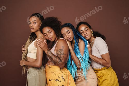 Preview: Young black four women hugging and posing at camera
