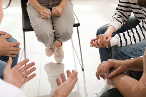 Preview: Psychotherapist working with group of drug addicted people at therapy session, closeup
