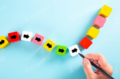 Preview: Businessman drawing an arrow on wooden block. Path for business growth success process concept.