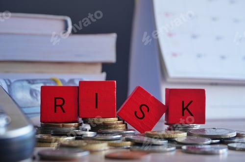 Preview: Wooden cubes with text RISK surrounded by calculator and money.