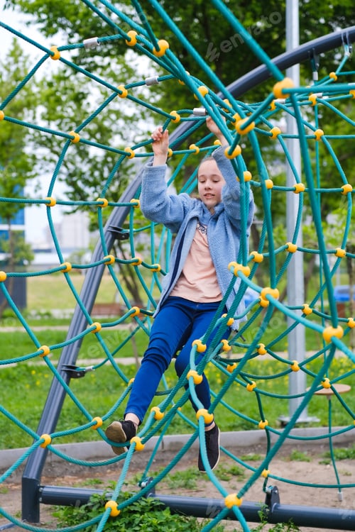 Preview: A middle school age teenager girl in a rope park. Joy and fun. Hobby. Recreational area in the city.
