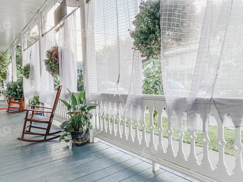 Preview: A beautiful summer breeze parts the curtains on an bright and expansive porch.