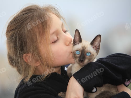 Preview: Young Girl Holding Kitten Outdoors