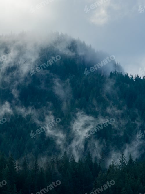 Preview: Misty Forest Mountain Range Shrouded in Clouds Above Howe Sound, BC, A Serene Alpine Landscape