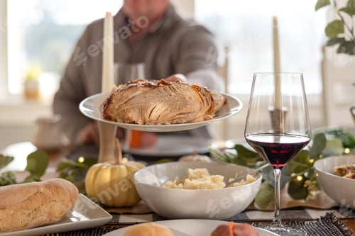 Preview: Passing food at a traditional holiday meal at home