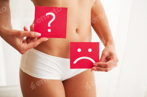 Preview: Female With Fit Slim Body Holding Cards With Sad Smiley Face and Question Mark Near Her Stomach