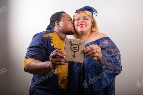 Preview: LGBT couple kisses and holds a sign with trans symbol, trans person kisses his girlfriend