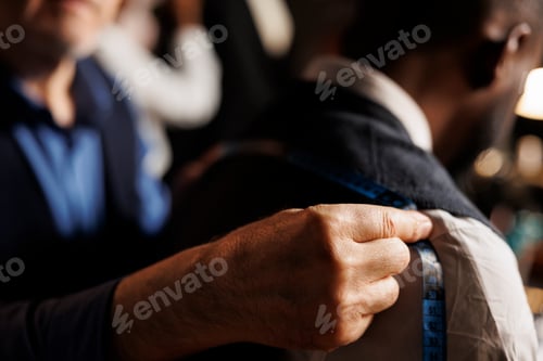 Preview: Close up of suitmaker doing fitting