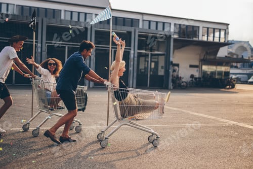Preview: Young friends racing with shopping carts