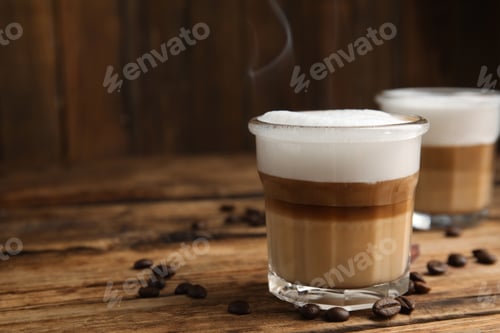 Preview: Delicious latte macchiato and coffee beans on wooden table, space for text