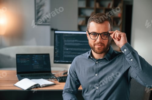 Preview: Man in formal clothes is working in the modern office. Using computer